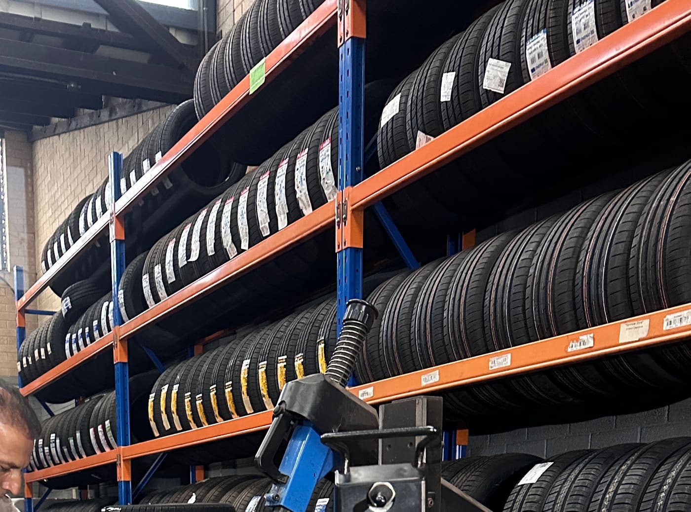 Racks of tyres along the workshop wall at SA Tyre & Auto