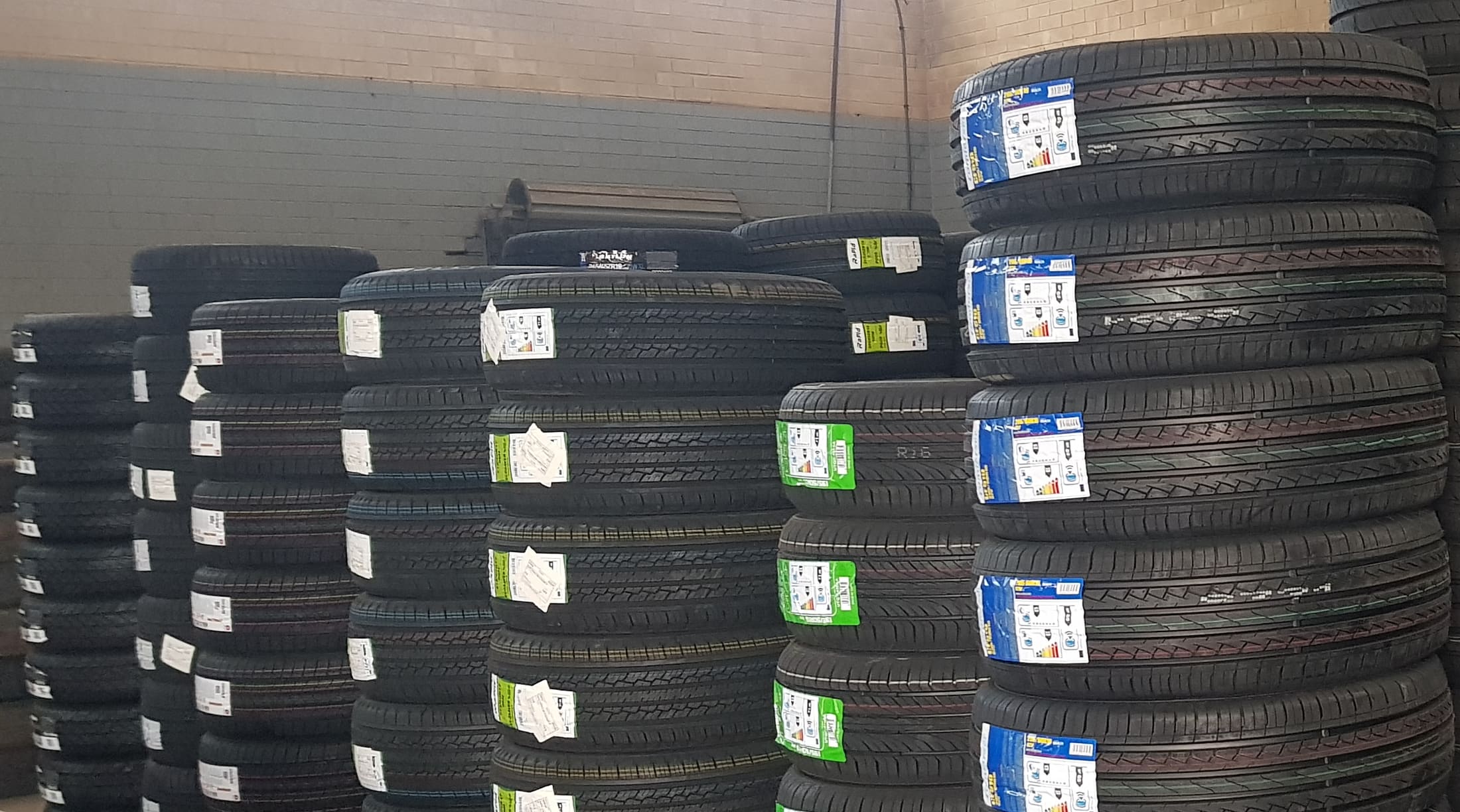 Stacks of new tyres on the floor of the SA Tyre & Auto workshop